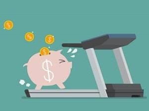Piggy bank on a treadmill exercising financial fasting