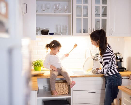 Mother and daughter in white kitchen
