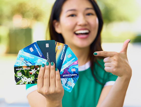 Young woman holding debit cards fanned out
