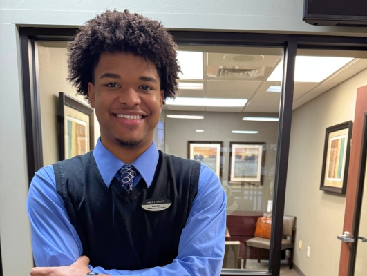 MIDFLORIDA employee standing in front of office