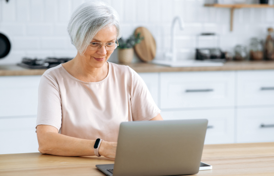 Mature woman using laptop in kitchen