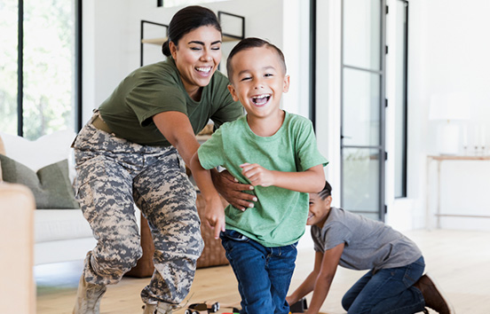 Military mom playing with kids in living room