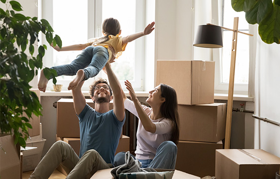 Family in living room with boxes 