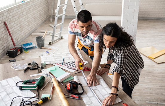 Couple measuring and renovating home
