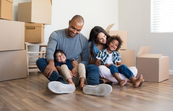 Happy family in home with boxes