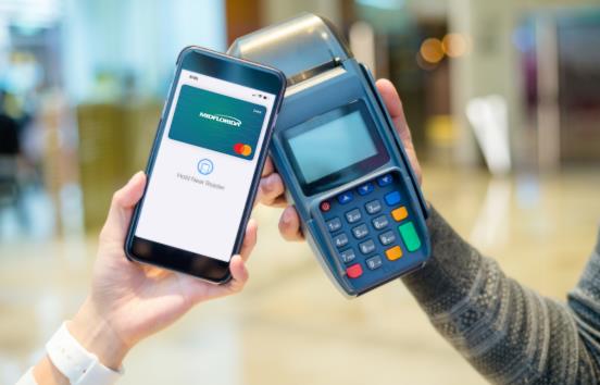 Person holding mobile wallet to POS device