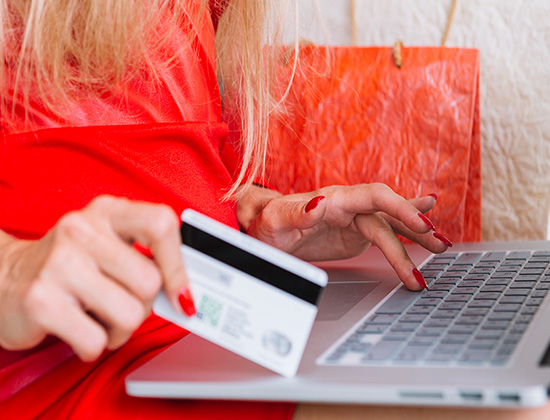 woman with card and computer