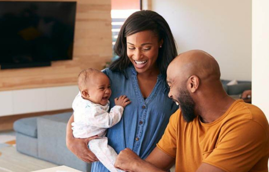 Young couple with baby laughing