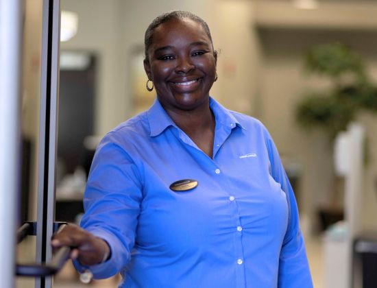 MIDFLORIDA Credit Union employee holding door open to welcome new members