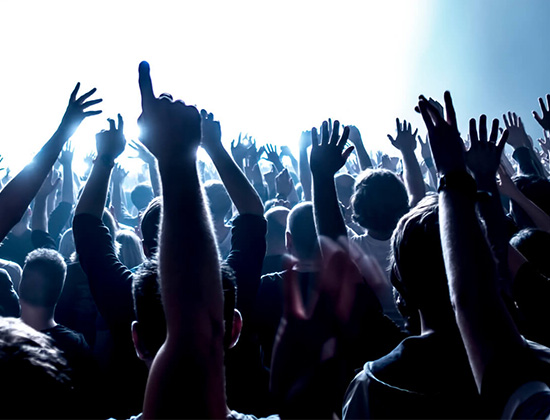 Concert audience with hands raised