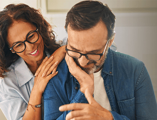 Couple in forties looking at papers together