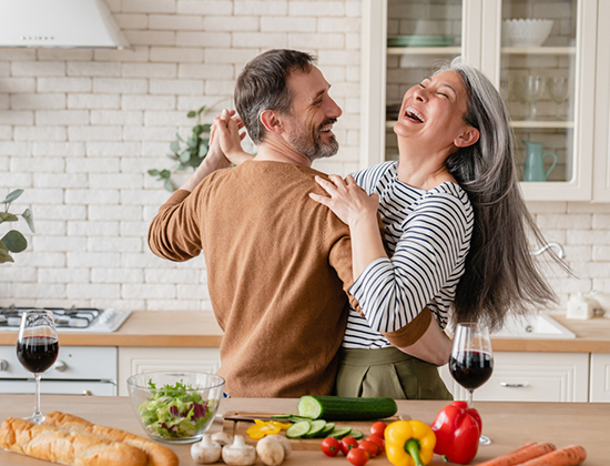 Happy couple dancing in kitchen 