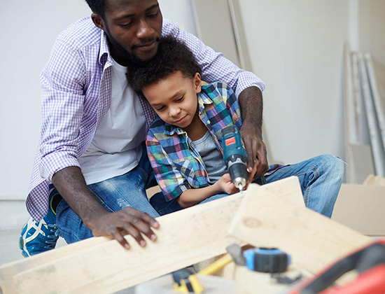 father and son building together 550x420