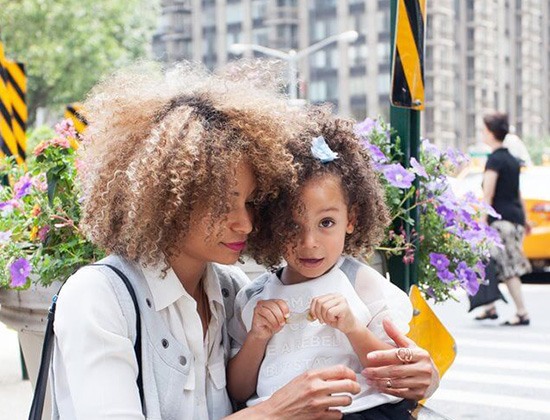 Mother and daughter in walkway in big city