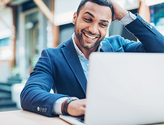Businessman sitting at laptop at table