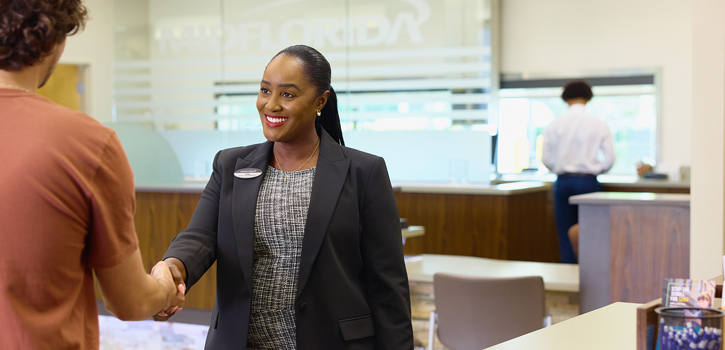 employee shaking member's hand