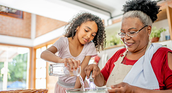 Grandma and grandaughter baking