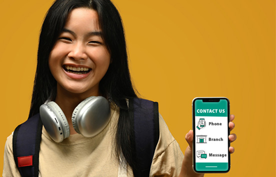 Asian teen girl holding up her mobile phone