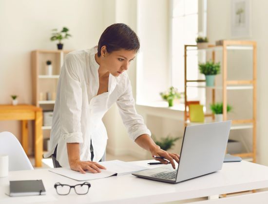 Female business owner at desk managing credit cards