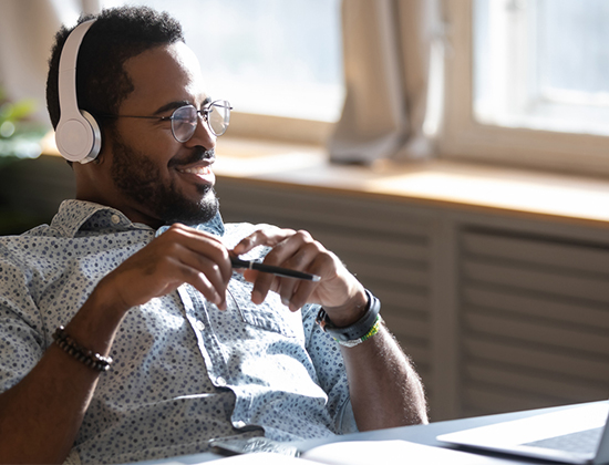 Business owner at desk looking relaxed using online wire transfer