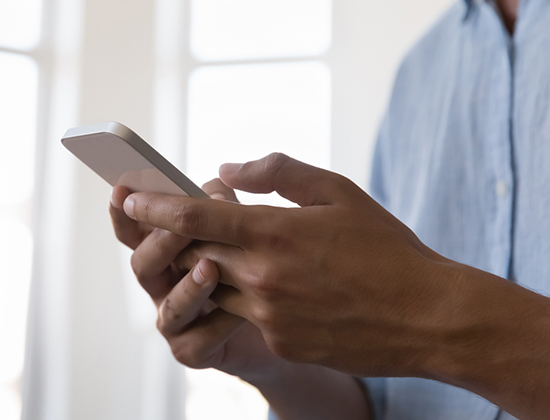Close up of man using business cell phone for mobile wallet