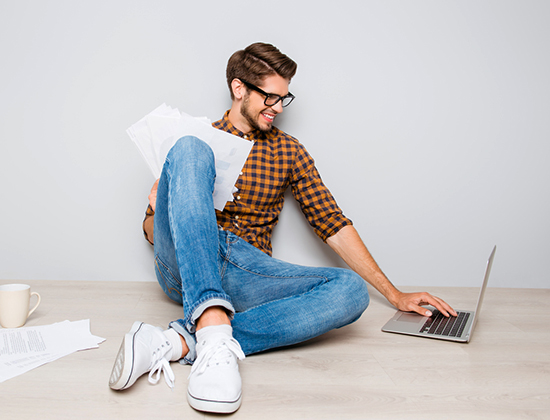 Man on floor easily paying his bill through free online bill pay