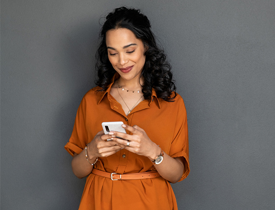 Woman holding mobile phone looking at free online banking account