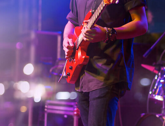 guitar player on stage at night