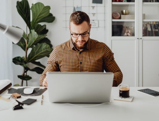 Business owner at desk reviewing IRA certificates