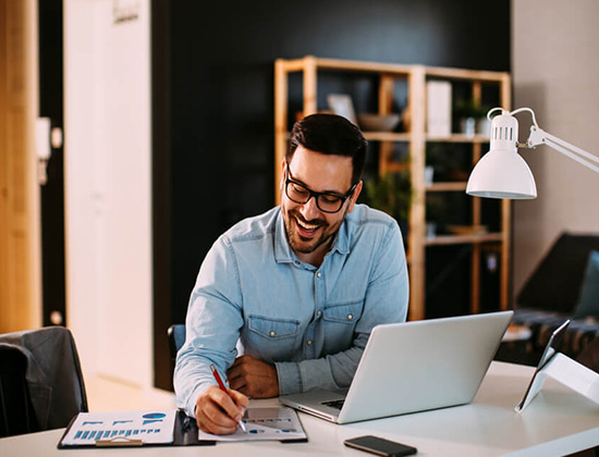 man smiling at desk