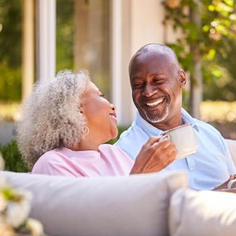 Mature couple drinking coffee outside