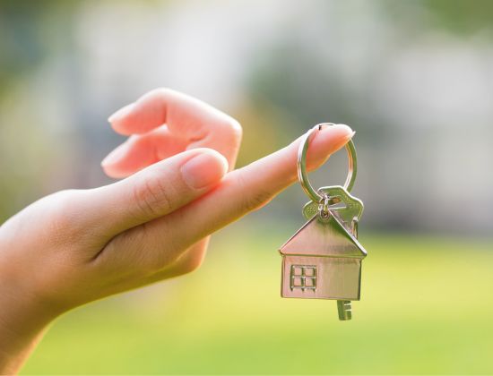 Female hand holding keys to new home 