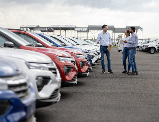 Couple on dealer lot with saleman