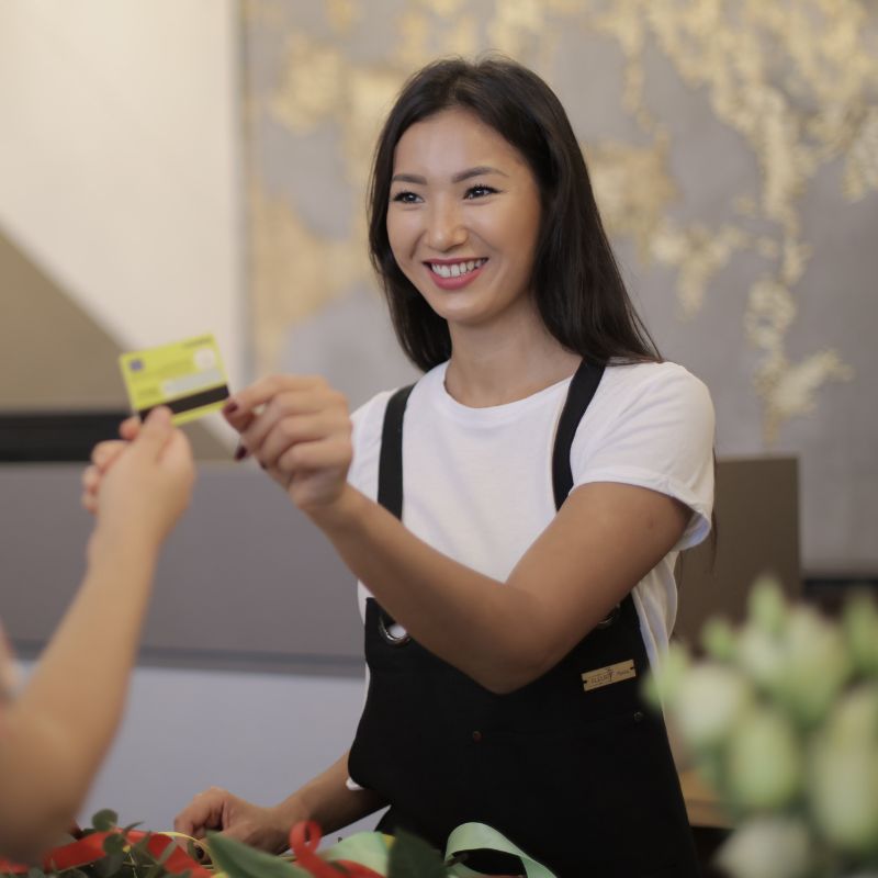 Young Asian woman holding a debit card