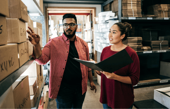 Two employees in stock room going over inventory