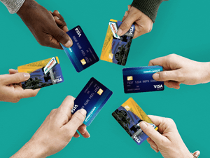 Six hands of people holding MIDFLORIDA Credit Union credit cards
