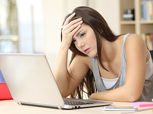 Teen female sitting in front of her computer after learning about financial scams