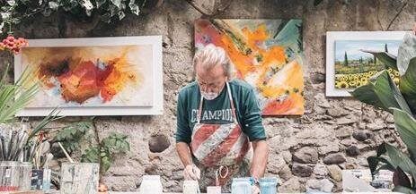 Retired man painting in his Lakeland art studio.